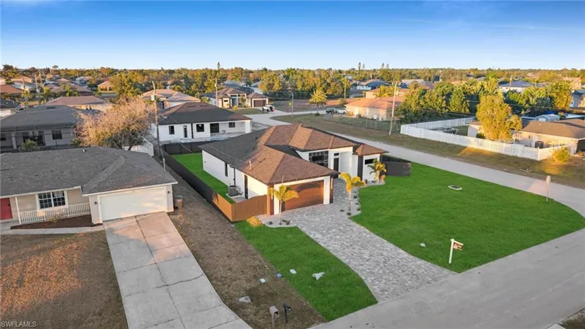 Rear view of house featuring a patio, a fenced backyard, stucco siding, and roof with shingles