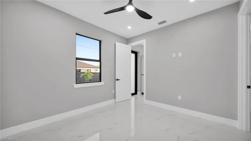 Unfurnished bedroom featuring light marble finish flooring, a ceiling fan, and recessed lighting