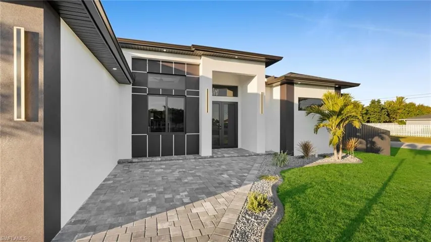 Property entrance featuring stucco siding and french doors