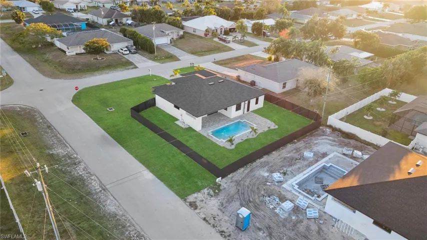 View of front facade with decorative driveway, a residential view, roof with shingles, and a garage