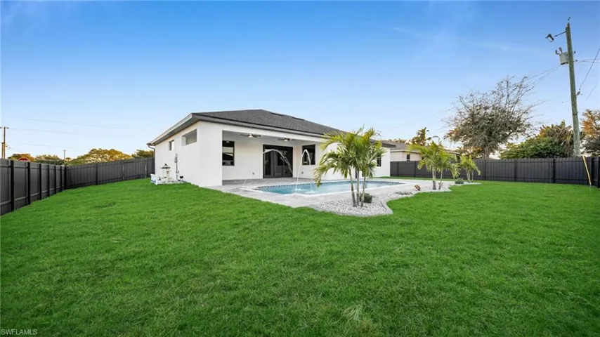 View of pool featuring patio surround and a fenced backyard