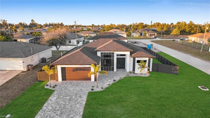 Back of property featuring a patio area, stucco siding, a fenced backyard, and a ceiling fan