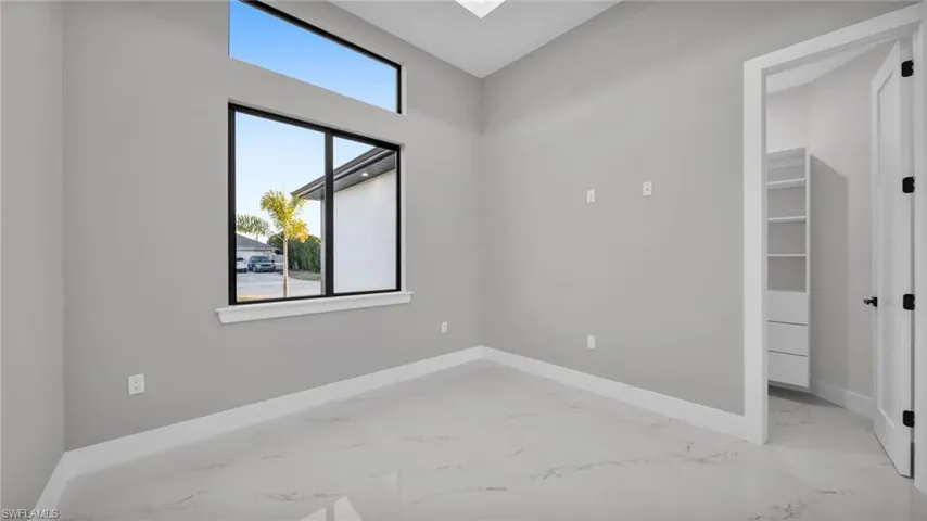 Empty room with baseboards and light marble finish flooring