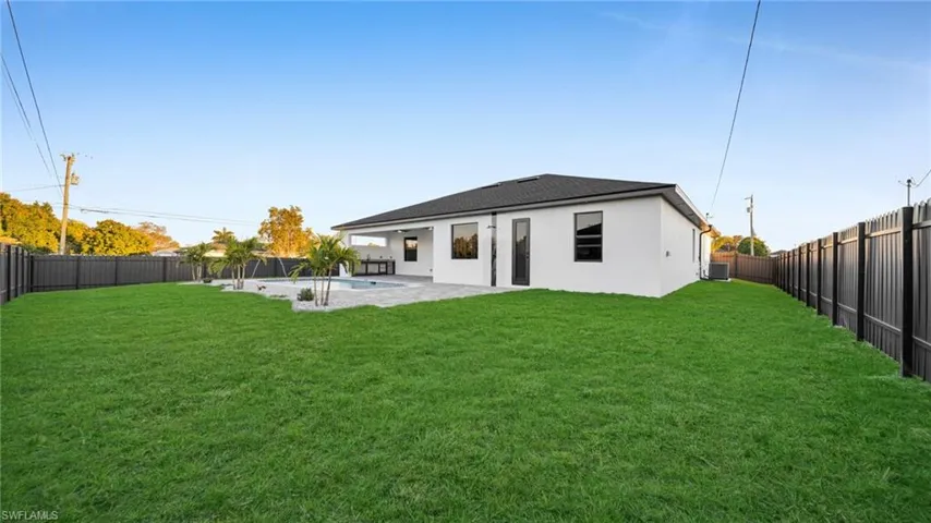Back of house featuring a patio, a fenced backyard, and stucco siding