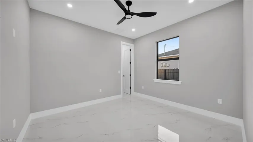 Empty room featuring light marble finish flooring, recessed lighting, and ceiling fan