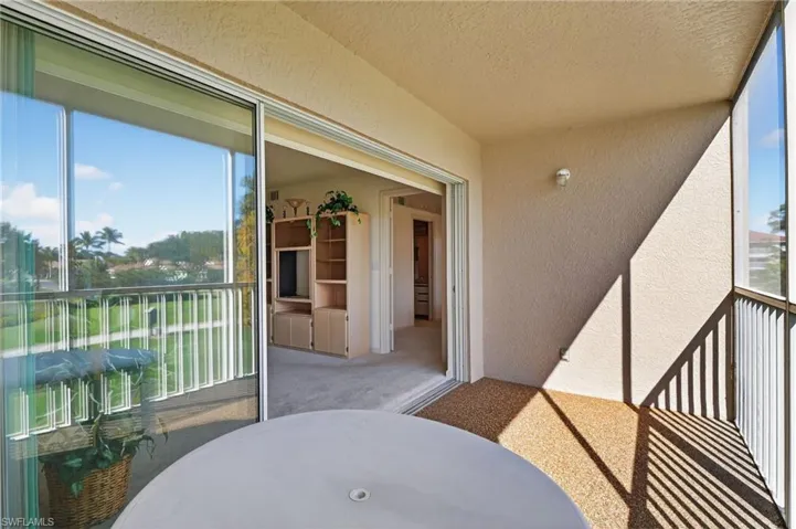Balcony featuring a sunroom