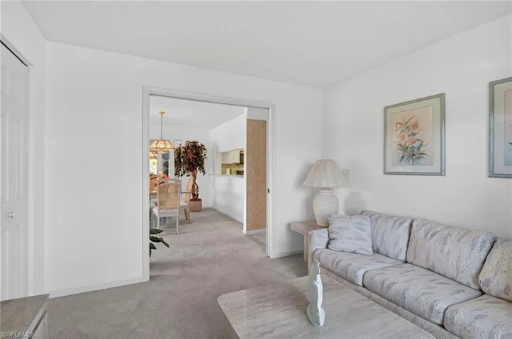 Living room featuring carpet flooring and baseboards