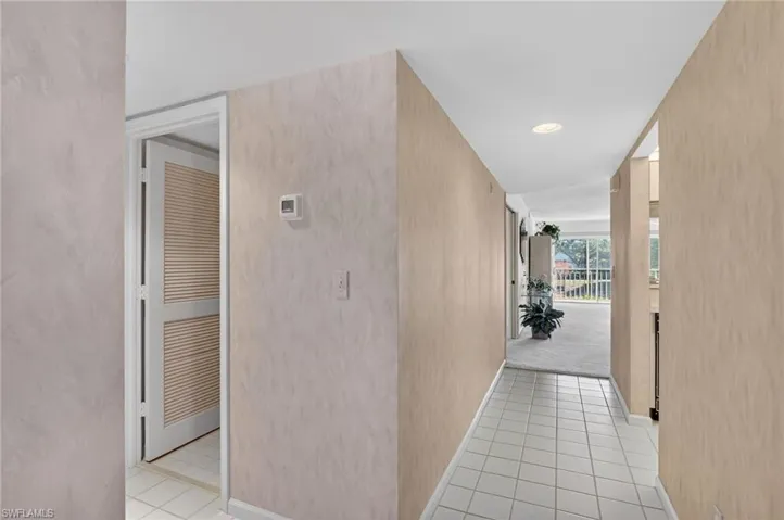 Hallway featuring light tile patterned floors and recessed lighting