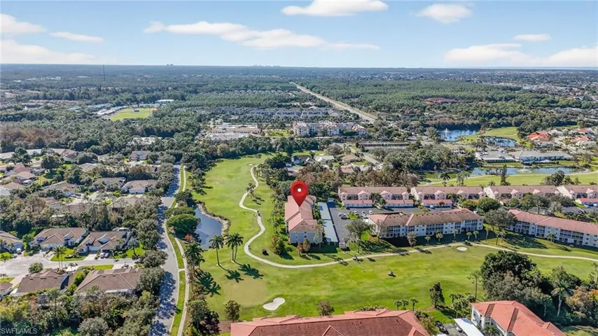 View of property location featuring a golf club and nearby suburban area