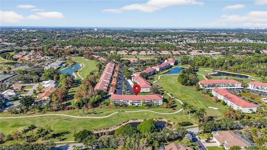 Aerial overview of property's location featuring a golf club, nearby suburban area, and a nearby body of water