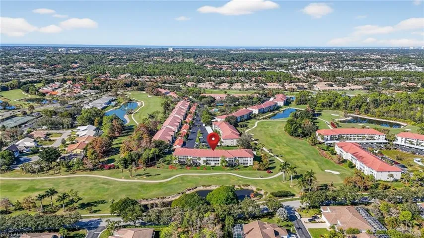 Aerial overview of property's location featuring a local golf course and nearby suburban area
