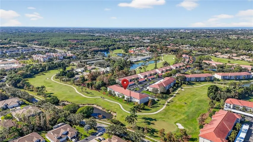 Aerial overview of property's location featuring a local golf course and nearby suburban area