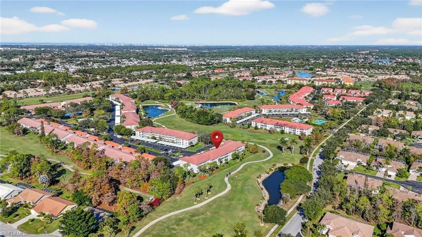 Aerial view of property and surrounding area with a nearby body of water and nearby suburban area