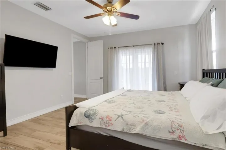 Bedroom featuring a ceiling fan and light wood-type flooring