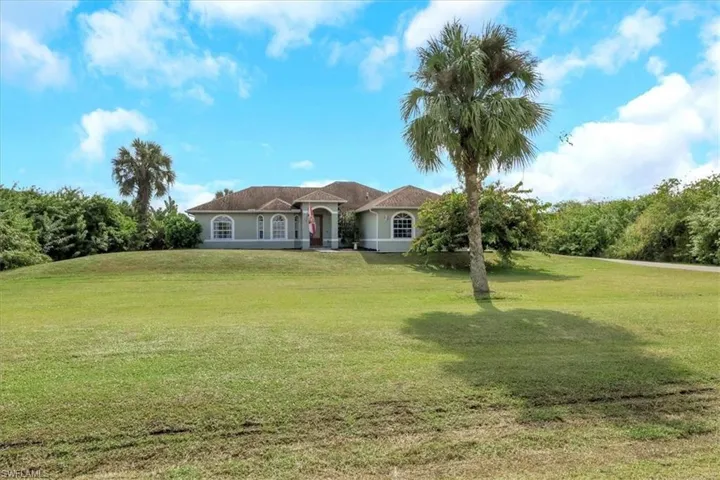 Mediterranean / spanish-style house featuring a front lawn