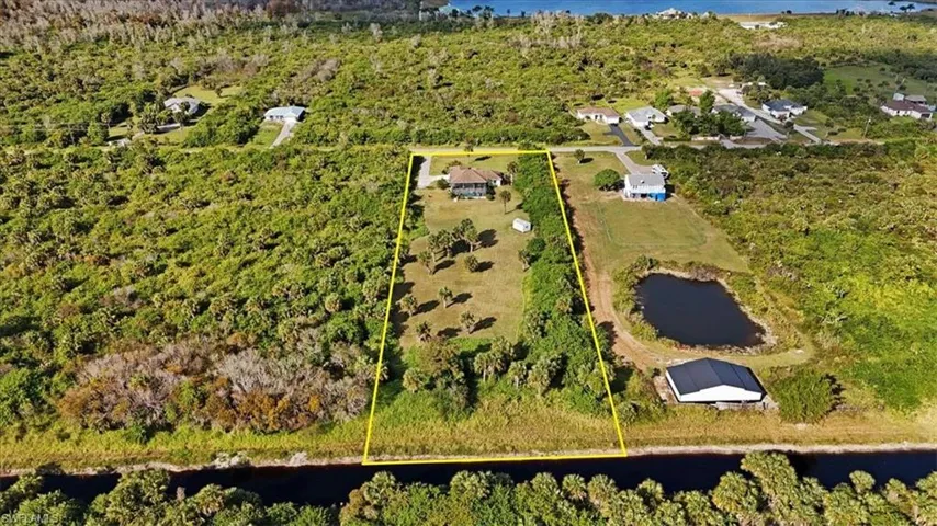 View of property location with a nearby body of water and property boundaries highlighted
