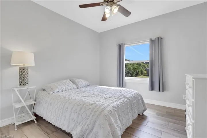 Bedroom with light wood-type flooring and a ceiling fan