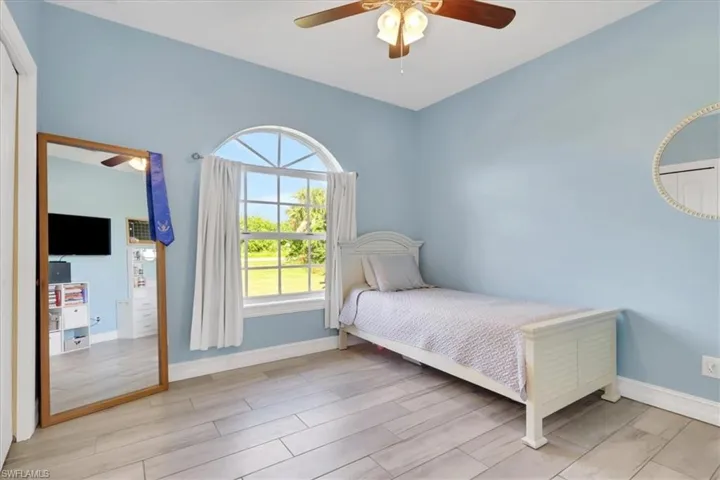 Bedroom featuring wood finish floors and ceiling fan