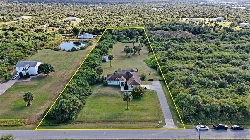View of rural area featuring property parcel outlined and a nearby body of water-New Roof