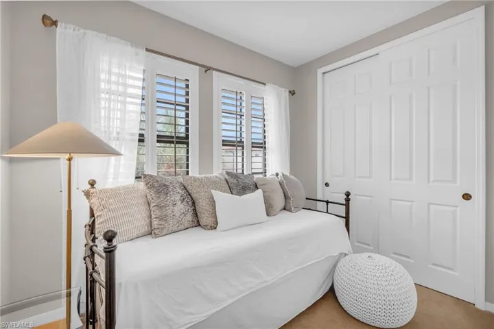 Carpeted bedroom with a closet