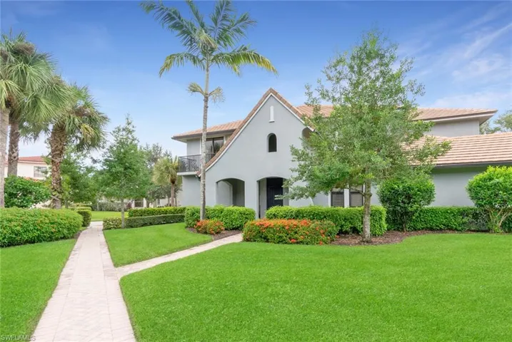 Mediterranean / spanish home featuring a balcony and a front lawn