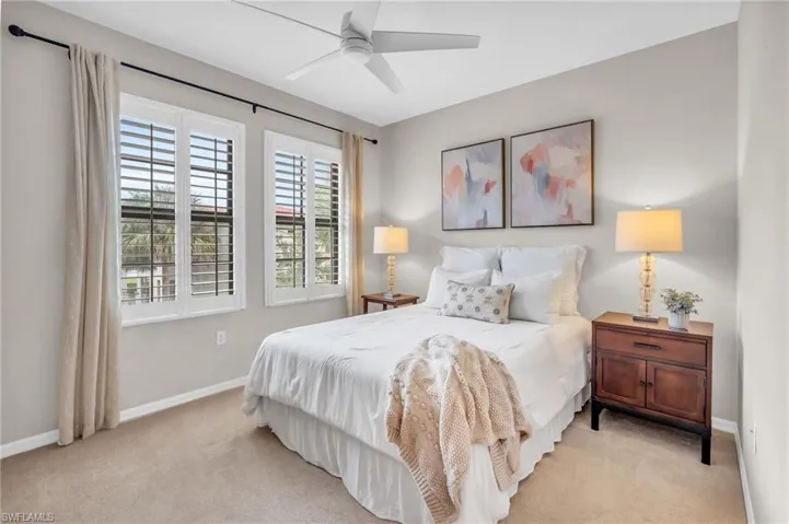Bedroom featuring ceiling fan and light carpet