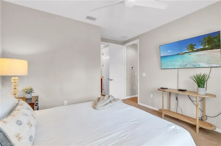 Bedroom with ceiling fan and carpet floors