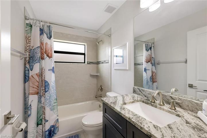 A tub/shower combo & more granite in the guest bathroom