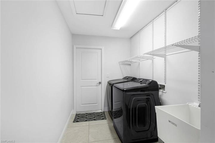Laundry room with convenient shelving & a laundry tub