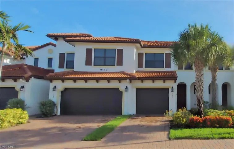 Mediterranean / spanish house featuring a garage, driveway, stucco siding, and a tile roof