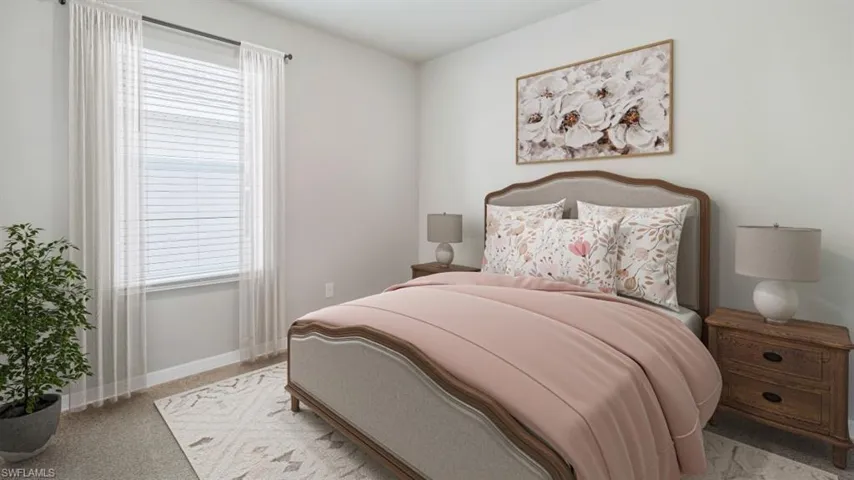 This image is virtually staged. Bedroom with baseboards and light colored carpet
