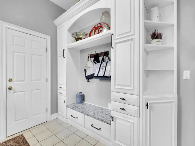 Mudroom with light tile patterned floors