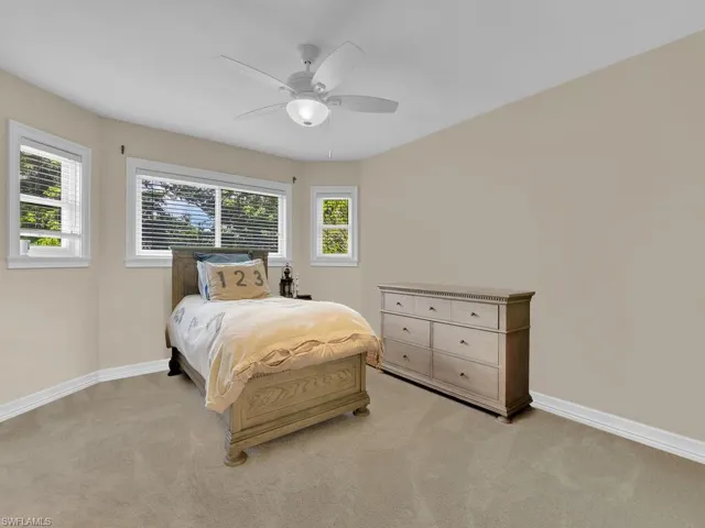 Bedroom featuring ceiling fan and light carpet