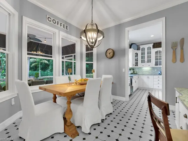 Dining room with crown molding and an inviting chandelier