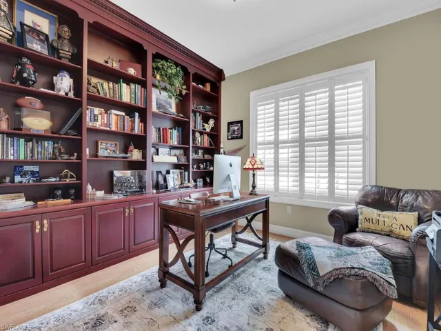 Office space with crown molding and light hardwood / wood-style flooring