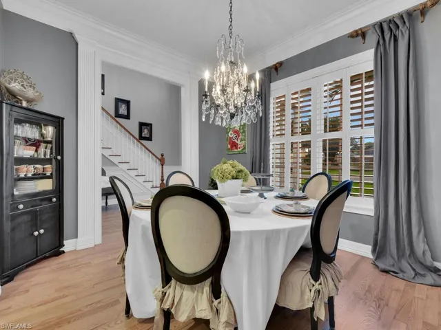 Dining area featuring a chandelier, light hardwood / wood-style floors, and ornamental molding