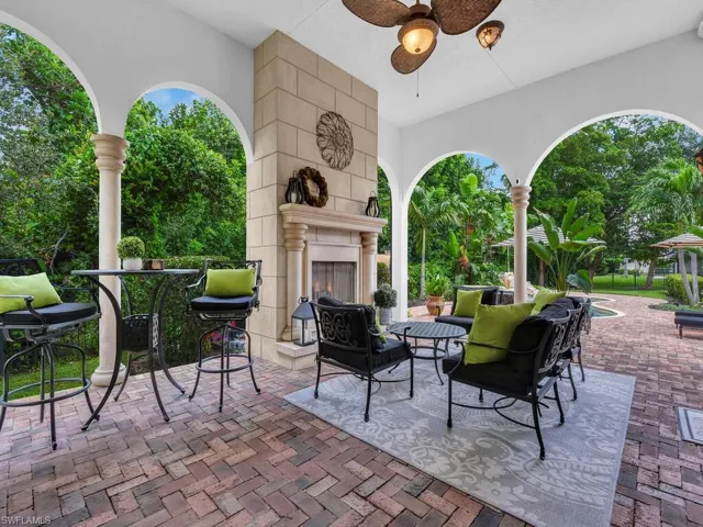 View of patio / terrace featuring ceiling fan and a fireplace