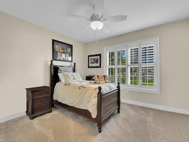 Bedroom featuring ceiling fan and light carpet
