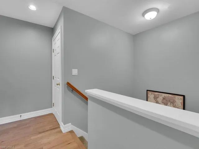 Hallway with wood-type flooring