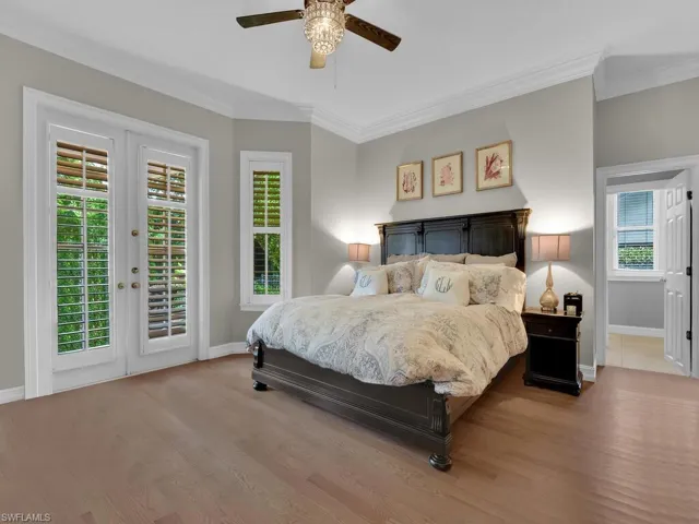 Bedroom featuring access to exterior, ceiling fan, ornamental molding, and wood-type flooring