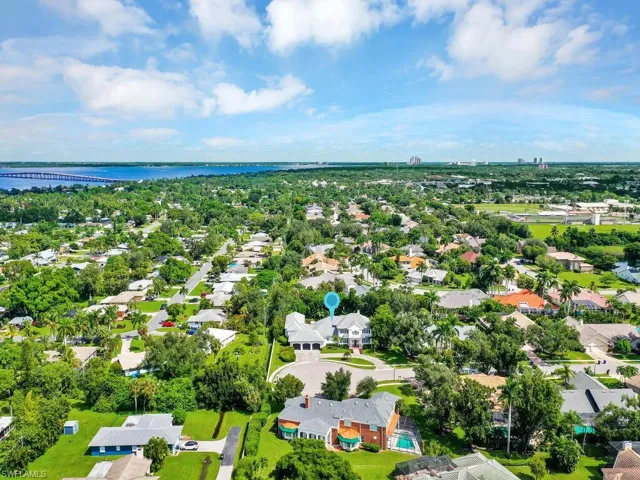 Birds eye view of property with a water view