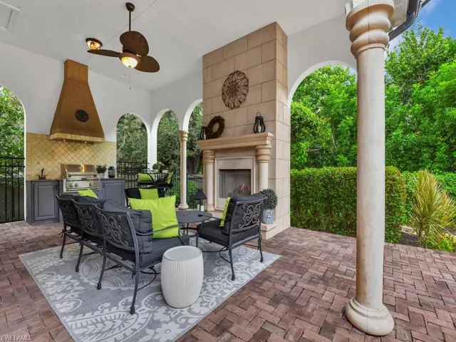 View of patio / terrace with exterior fireplace, grilling area, area for grilling, and ceiling fan