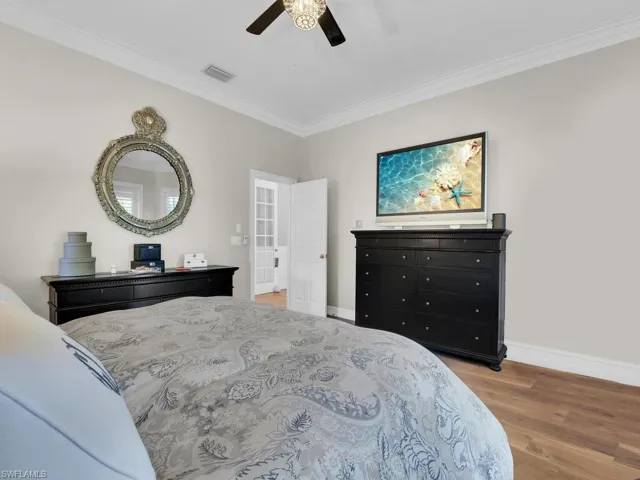 Bedroom featuring ornamental molding, ceiling fan, and light hardwood / wood-style floors