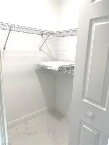 Walk in closet with marble look tiles