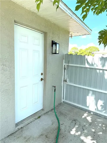 View of exterior entry featuring stucco siding