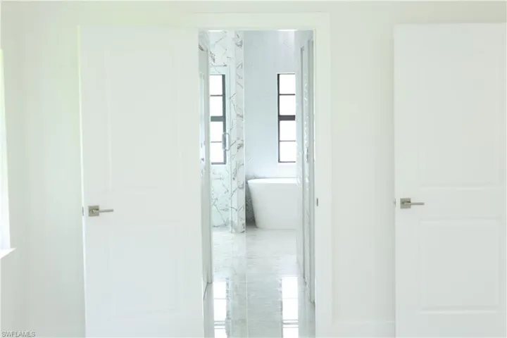 Bathroom with marble finish floors and double vanity