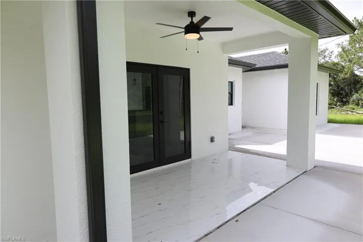 View of patio / terrace with an outdoor living space with a fire pit, a ceiling fan, and french doors
