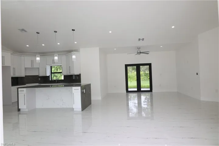 Corridor featuring recessed lighting and light marble finish floors