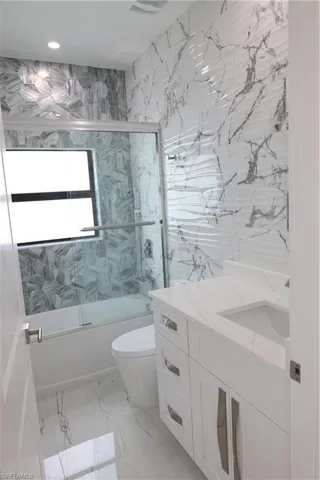 Bathroom with vanity and marble finish floors
