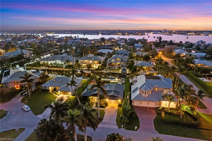 Aerial view at dusk featuring a water view